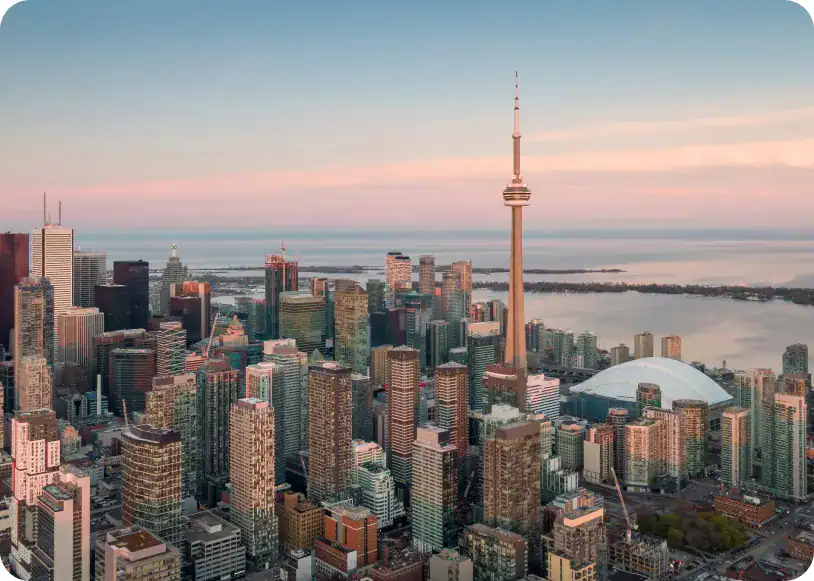 Modern Toronto skyline featuring the CN Tower and Rogers Centre at sunset for urban photography enthusiasts.